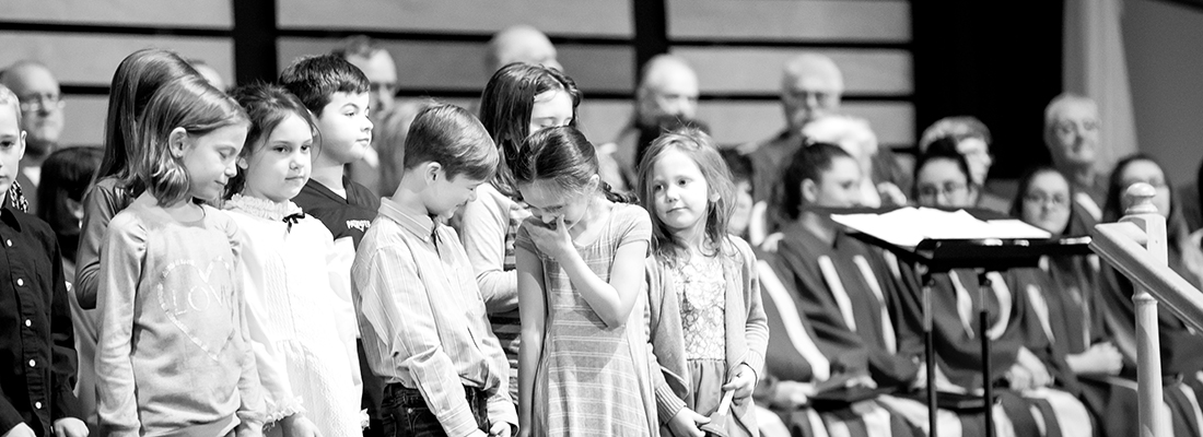 Sunday school students laugh as they sing for Sunday morning service at Fair Haven Baptist Church